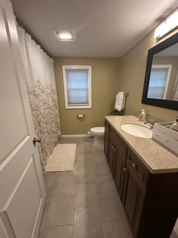 a bathroom with a double vanity sink and mirror