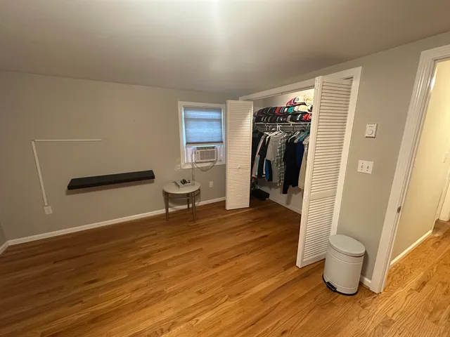 a view of a room with wooden floor and sink