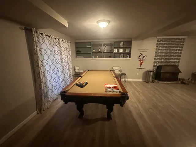 a room with pool table and glass door