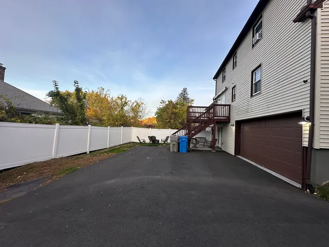 a backyard of a house with table and chairs