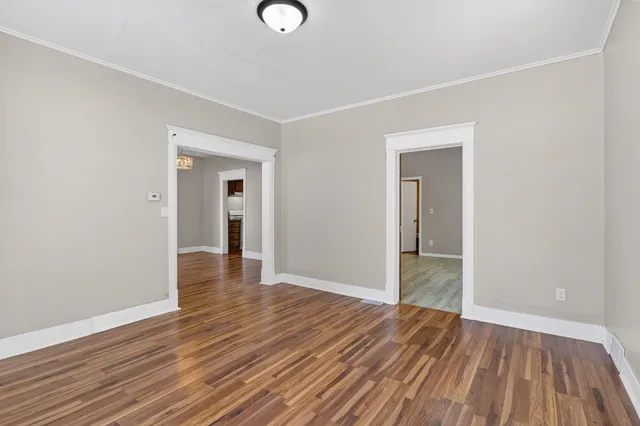 an empty room with wooden floor and closet
