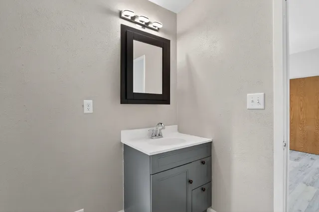a bathroom with a sink and a mirror