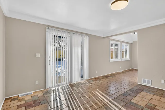 a view of a room with wooden floor and windows