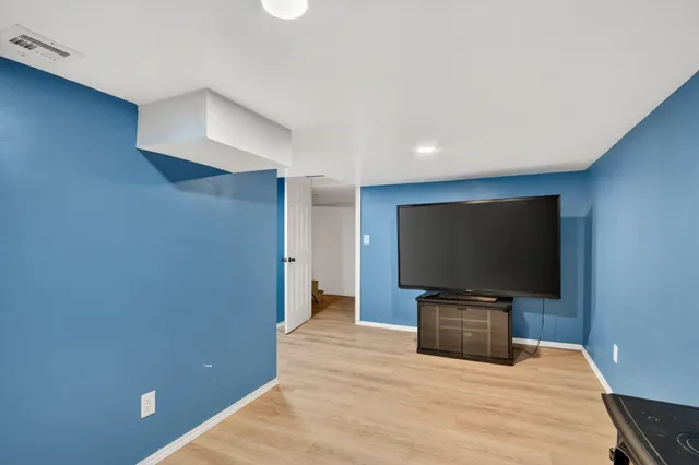 a room with furniture and a flat screen tv