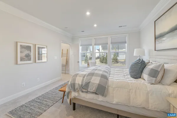 a bedroom with a bed and glass window