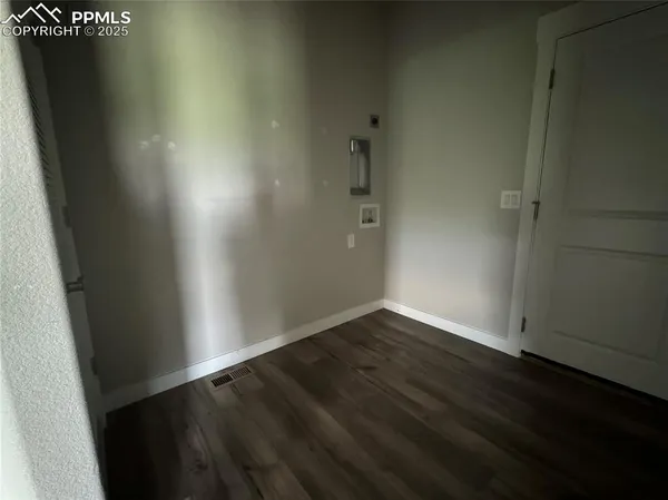 an empty room with wooden floor