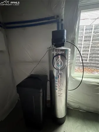 a water heater on the side of a window