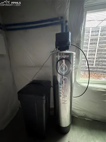 a water heater on the side of a window