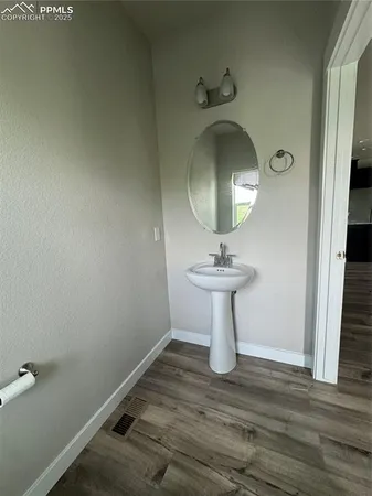 a bathroom with a sink toilet and a mirror