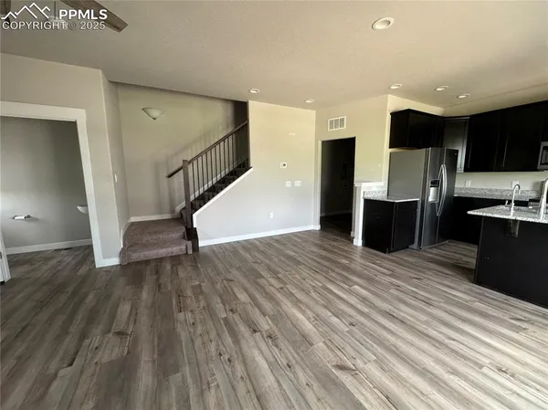 a view of kitchen with furniture and wooden floor