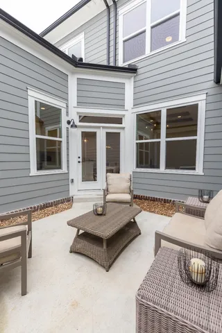 front view of house with a chairs and table in the patio