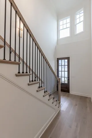 a view of staircase with white walls and a window