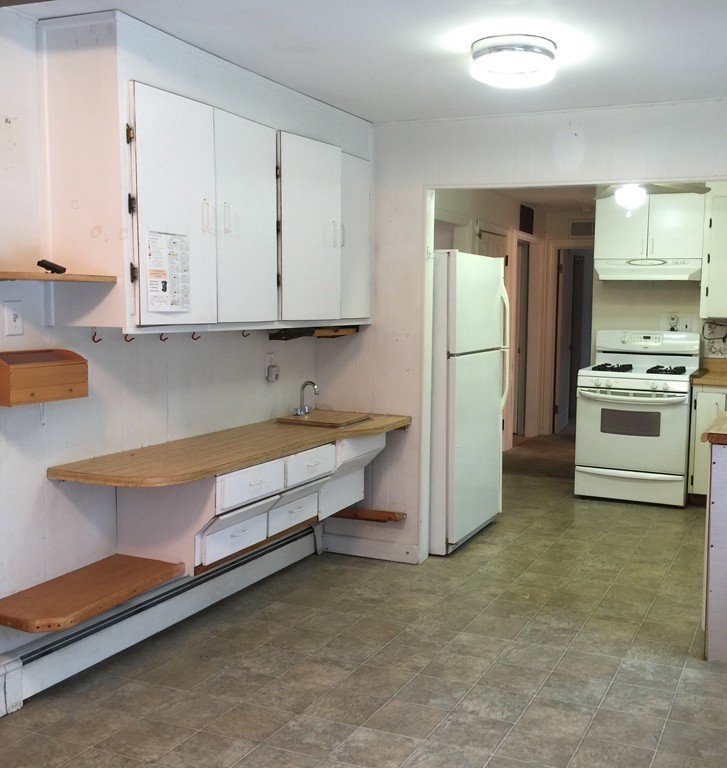 9 Claire Road Amesbury, MA 01913 - Photo 17 of 26 a kitchen with refrigerator and white cabinets