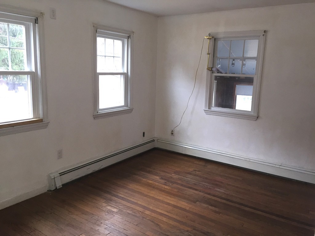 9 Claire Road Amesbury, MA 01913 - Photo 21 of 26 an empty room with wooden floor and windows