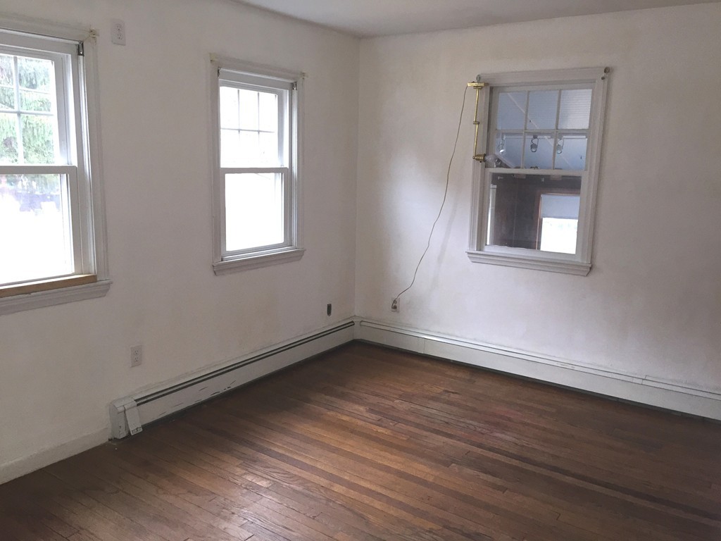 9 Claire Road Amesbury, MA 01913 - Photo 22 of 26 an empty room with wooden floor and windows