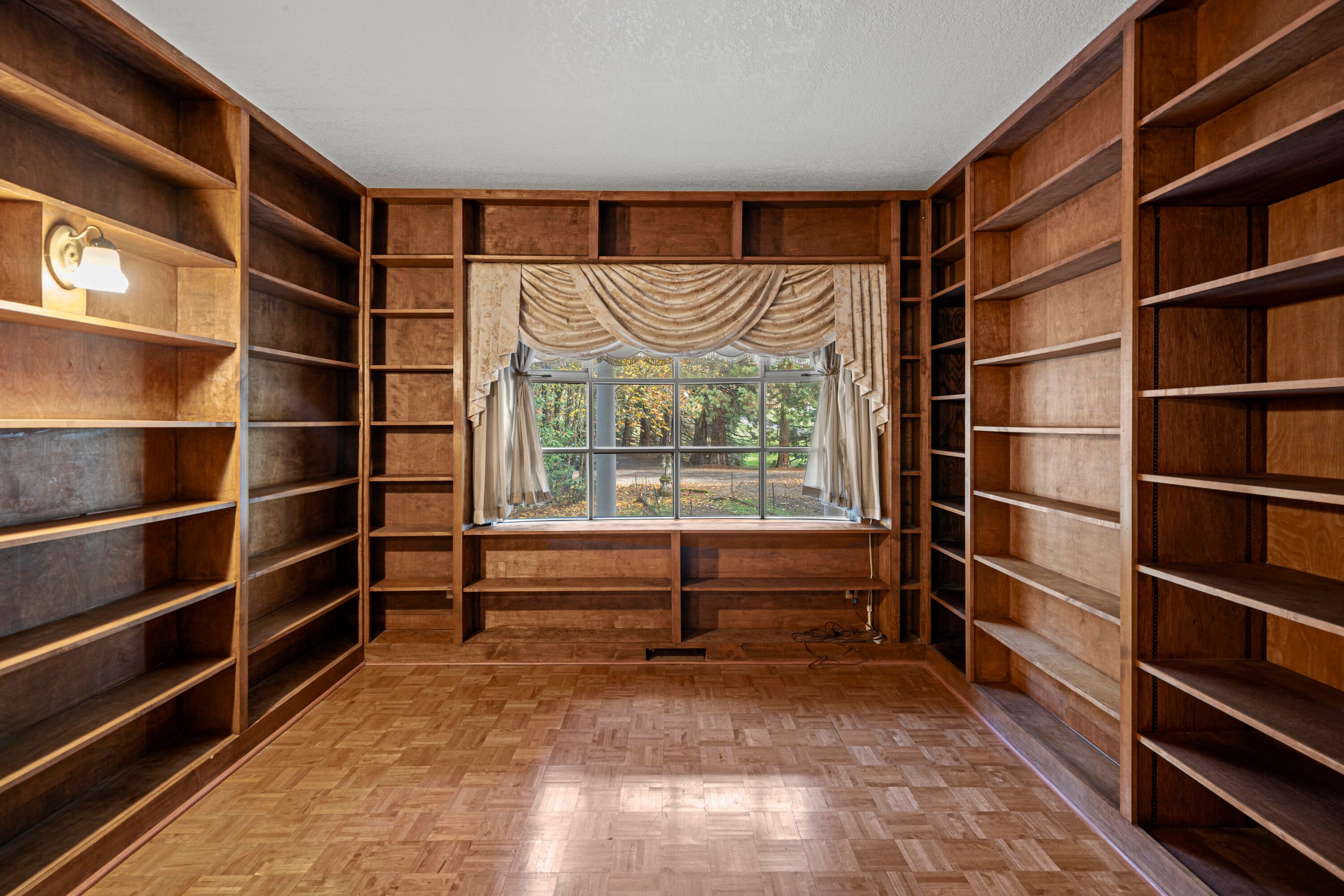 7771 Old Stage Road Central Point, OR 97502 - Photo 14 of 42 Library with parkay flooring and bookcases, 1/2 bath