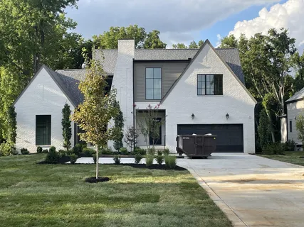 a front view of house with a garden