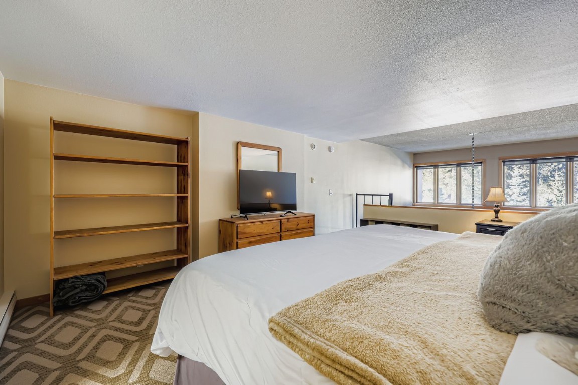 22340 Highway 6, Unit 1784 Keystone, CO 80435 - Photo 11 of 28 a bedroom with a bed and a flat screen tv