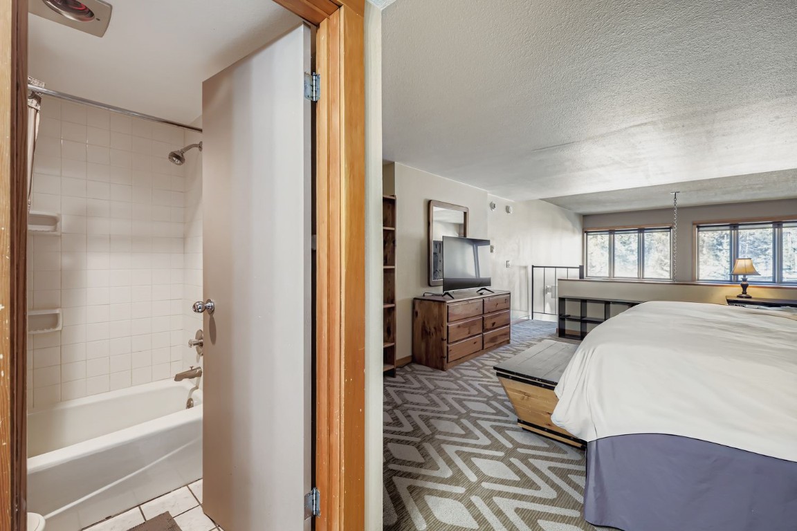 22340 Highway 6, Unit 1784 Keystone, CO 80435 - Photo 15 of 28 a spacious bedroom with a bed and a couch