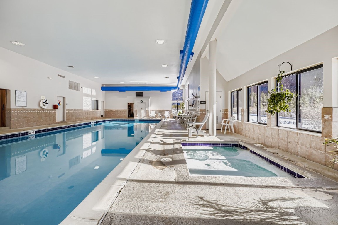 22340 Highway 6, Unit 1784 Keystone, CO 80435 - Photo 26 of 28 a large kitchen with kitchen island a stove a sink and a dining table view