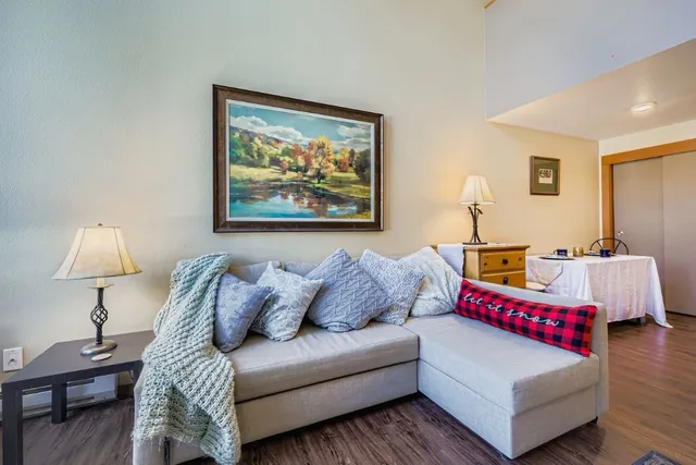 a living room with furniture and a lamp