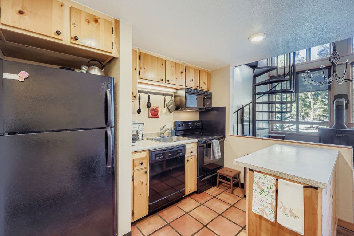 22340 Highway 6, Unit 1784 Keystone, CO 80435 - Photo 4 of 28 a kitchen with stainless steel appliances granite countertop a refrigerator a stove and a sink