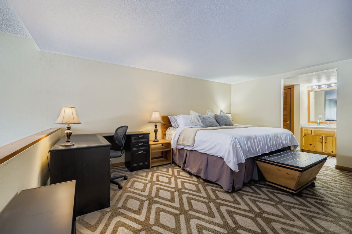 22340 Highway 6, Unit 1784 Keystone, CO 80435 - Photo 9 of 28 a bedroom with a bed and wooden floor