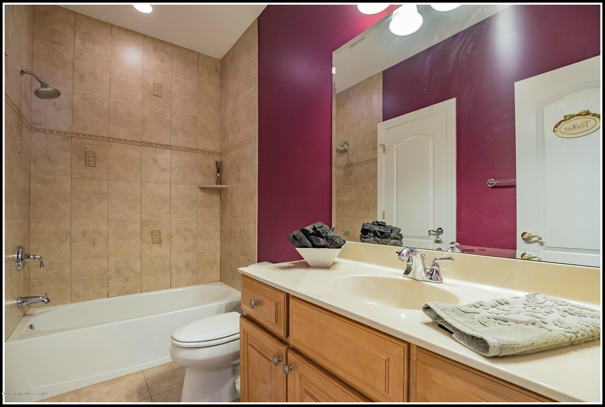 198 Robertsville Road Freehold, NJ 07728 - Photo 18 of 30 a bathroom with a granite countertop sink a toilet a mirror and bathtub