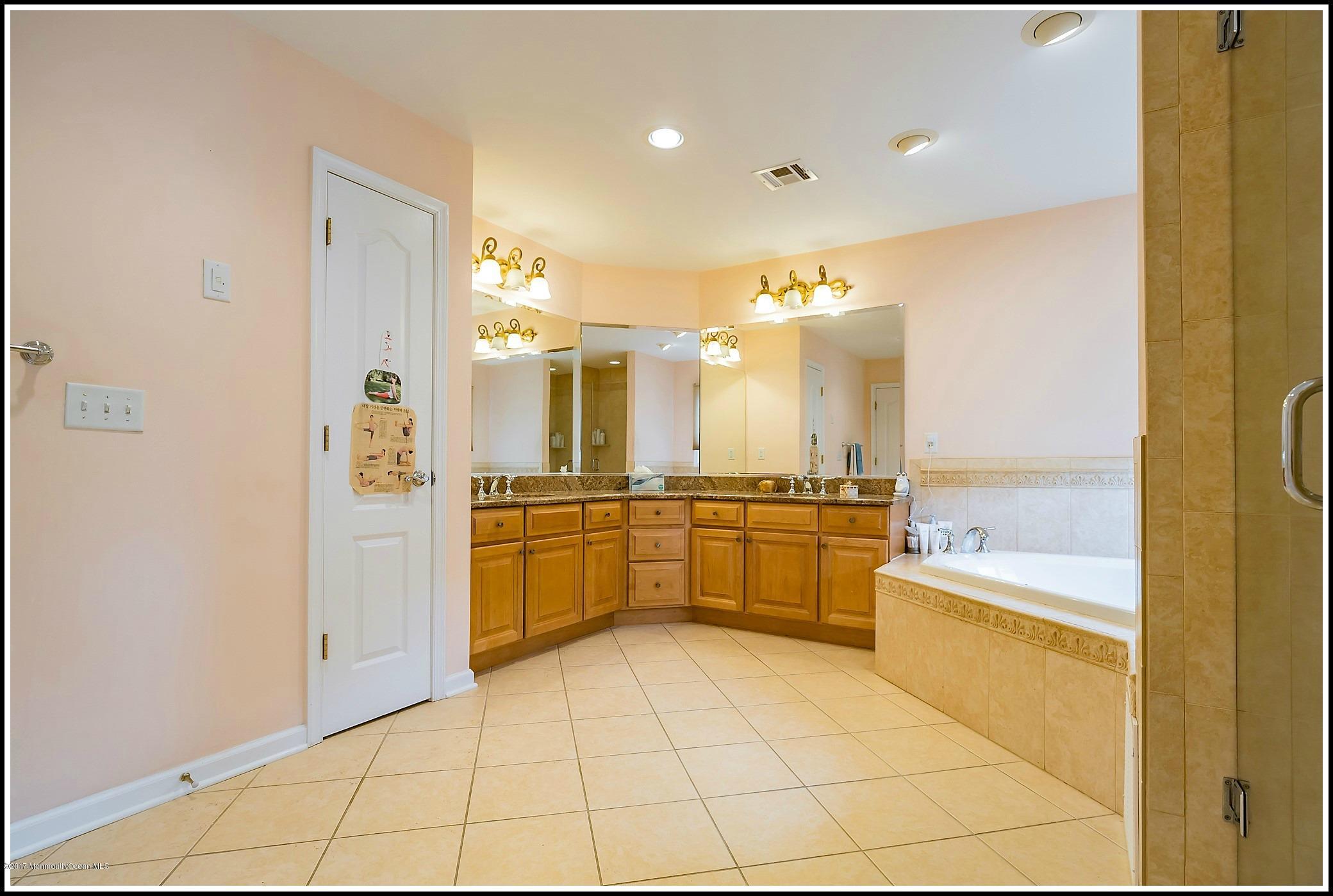 198 Robertsville Road Freehold, NJ 07728 - Photo 22 of 30 a large bathroom with a large mirror vanity and a shower