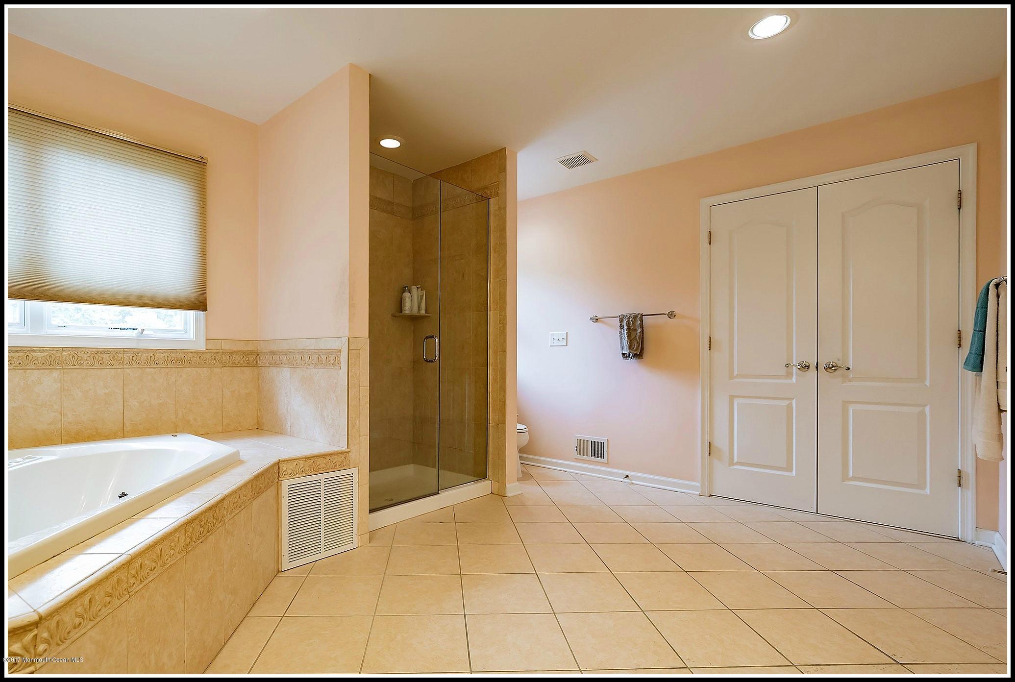198 Robertsville Road Freehold, NJ 07728 - Photo 23 of 30 a bathroom with a tub shower and sink