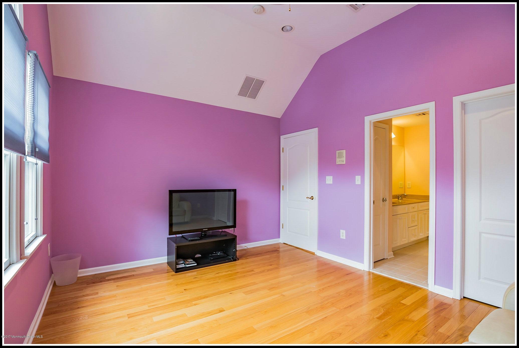 198 Robertsville Road Freehold, NJ 07728 - Photo 26 of 30 a bedroom with a bed and a flat screen tv