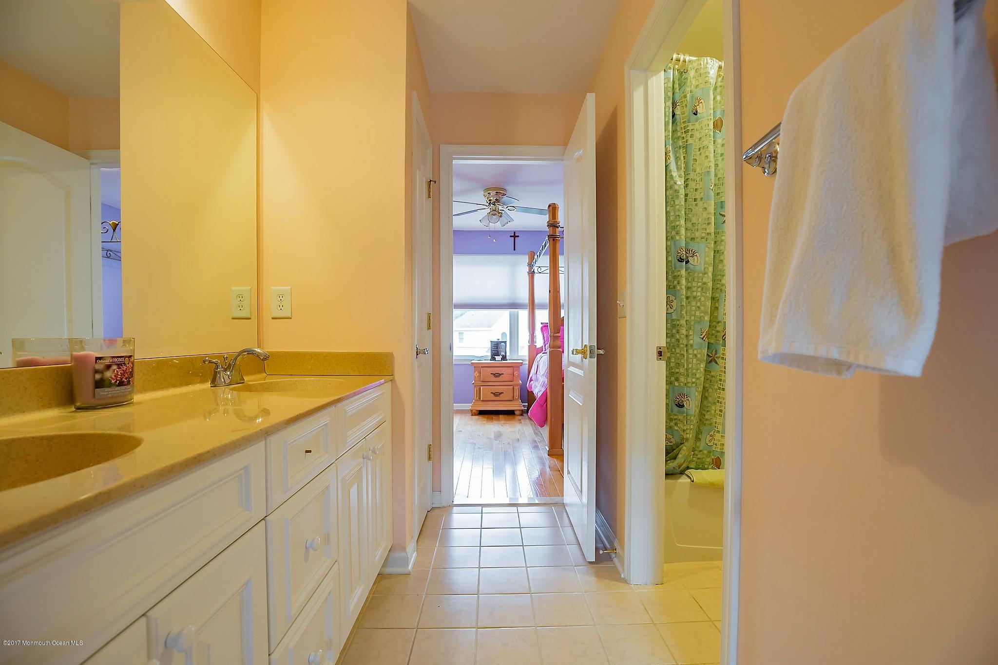 198 Robertsville Road Freehold, NJ 07728 - Photo 27 of 30 a en suite bathroom with a granite countertop sink and a mirror