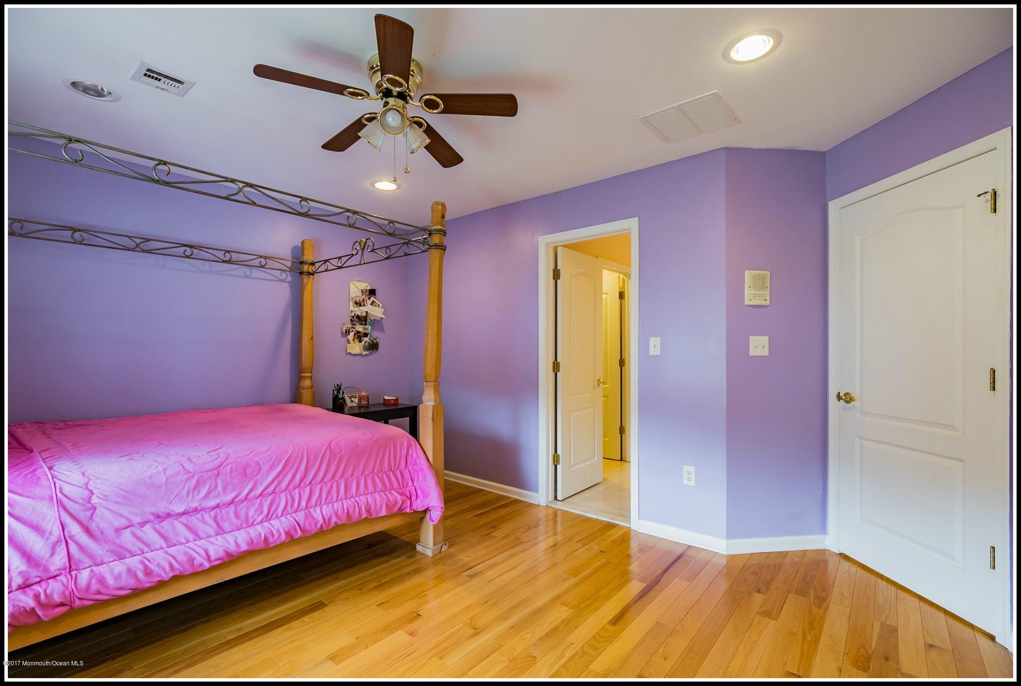 198 Robertsville Road Freehold, NJ 07728 - Photo 28 of 30 a bedroom with a bed chandelier and a window