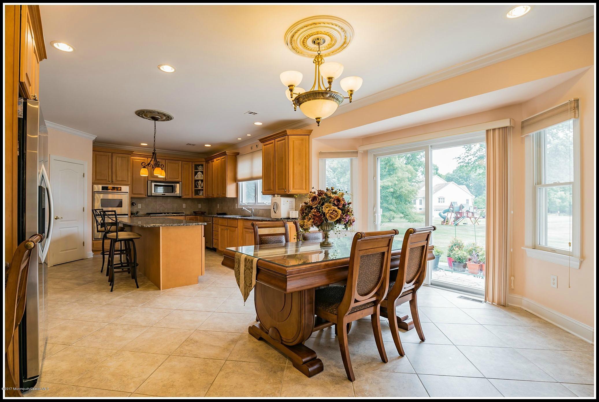 198 Robertsville Road Freehold, NJ 07728 - Photo 6 of 30 a dining room with furniture and a kitchen view