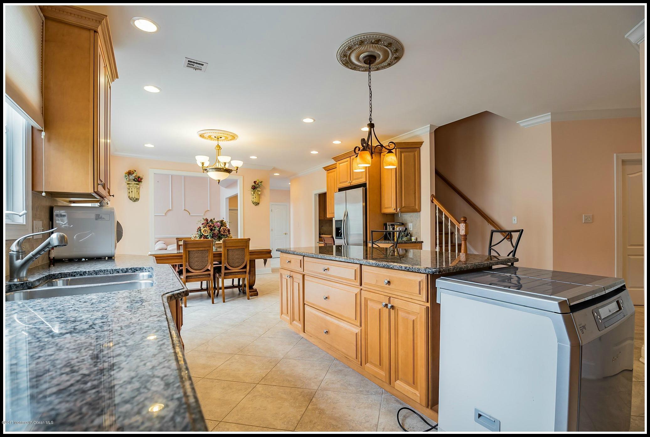 198 Robertsville Road Freehold, NJ 07728 - Photo 7 of 30 a kitchen with stainless steel appliances granite countertop a stove and a sink