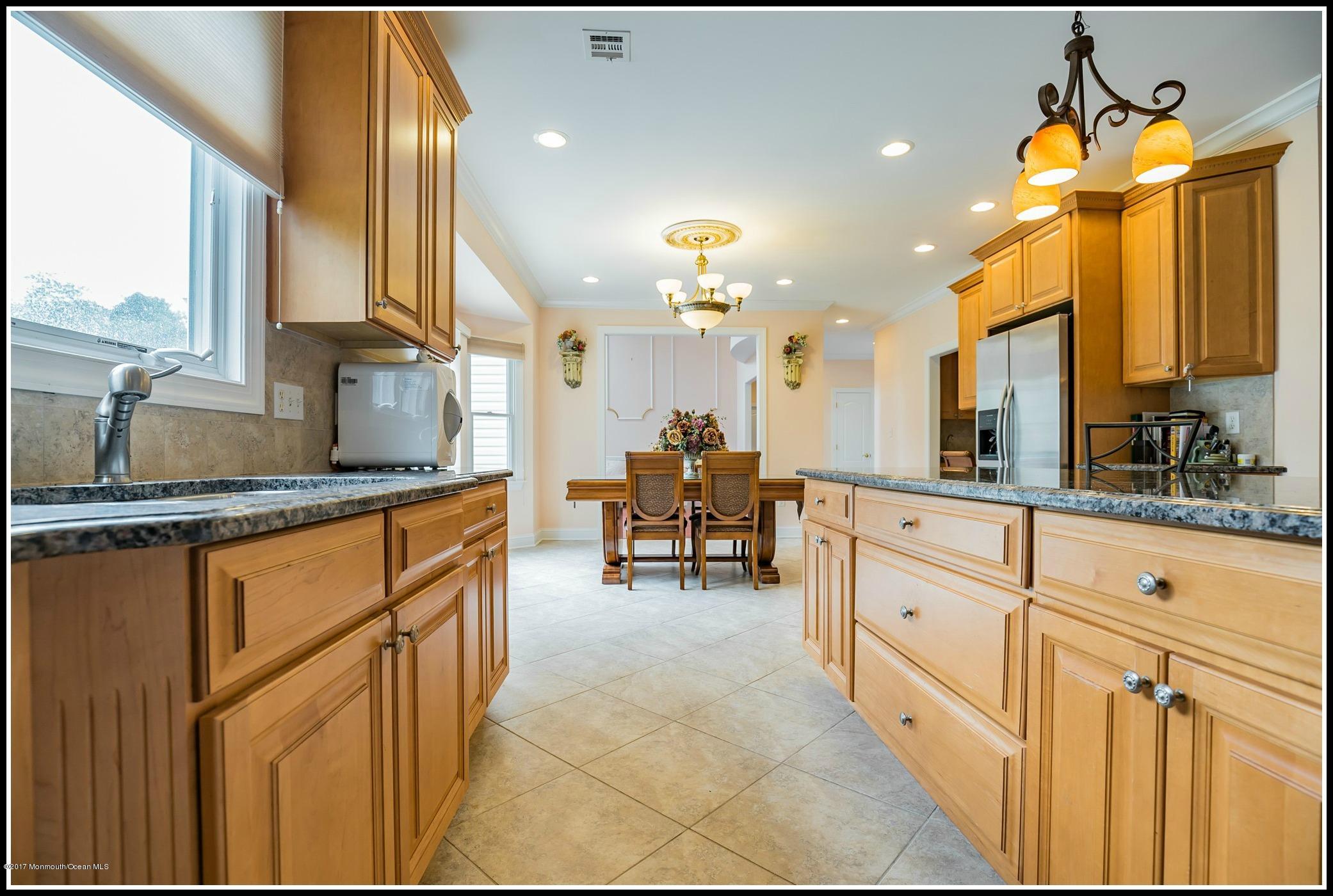 198 Robertsville Road Freehold, NJ 07728 - Photo 8 of 30 a kitchen with granite countertop a sink cabinets and window