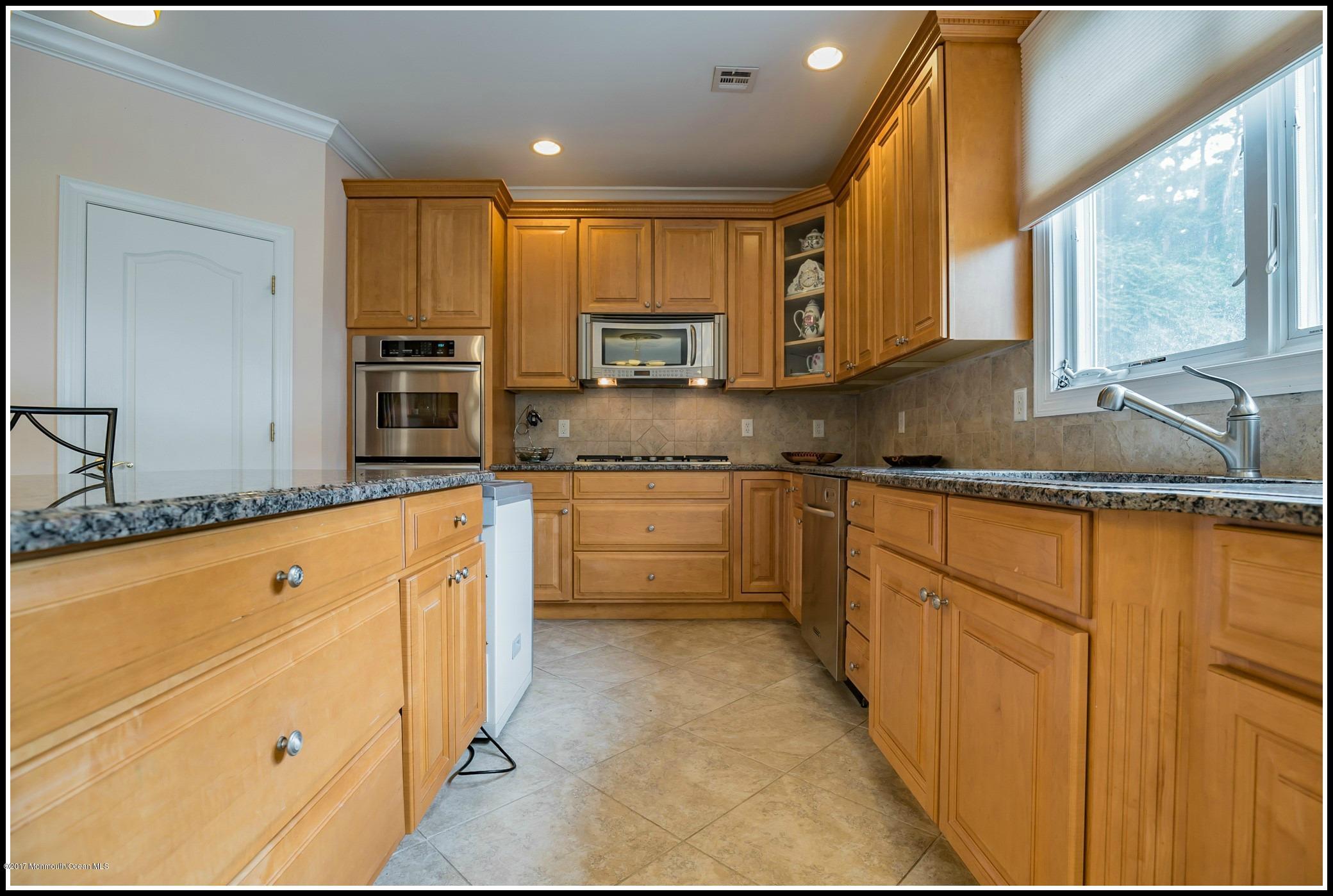 198 Robertsville Road Freehold, NJ 07728 - Photo 10 of 30 a kitchen with granite countertop a sink stainless steel appliances and cabinets