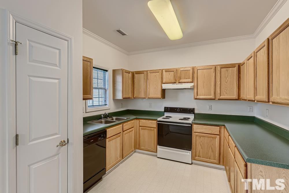 205 Bridgepath Drive Cary, NC 27513 - Photo 11 of 28 a kitchen with a sink dishwasher a stove and a refrigerator