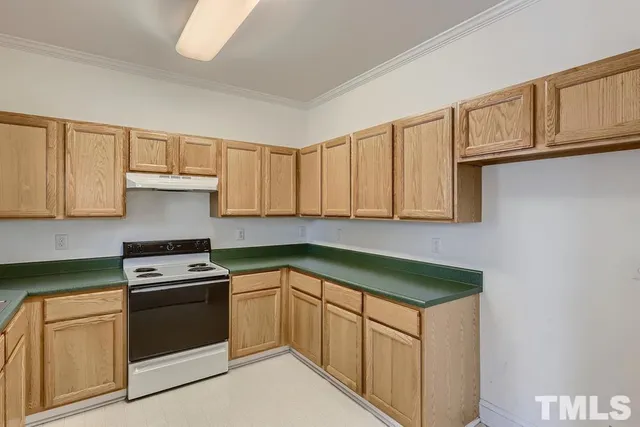 a kitchen with granite countertop white cabinets and white appliances