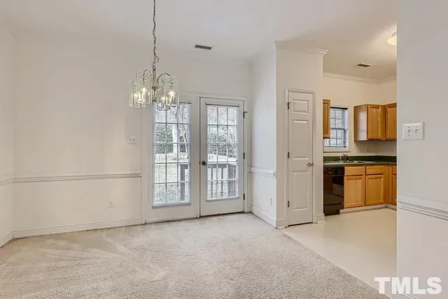 a view of a kitchen with refrigerator and cabinets