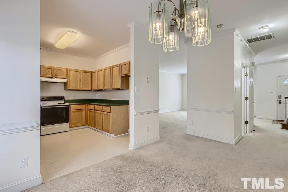 205 Bridgepath Drive Cary, NC 27513 - Photo 16 of 28 a kitchen with a refrigerator and a stove top oven