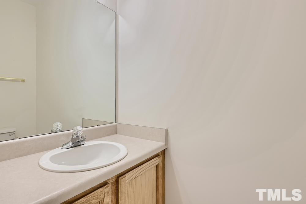 205 Bridgepath Drive Cary, NC 27513 - Photo 17 of 28 a bathroom with a sink and a mirror