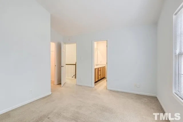 a view of an empty room and a window