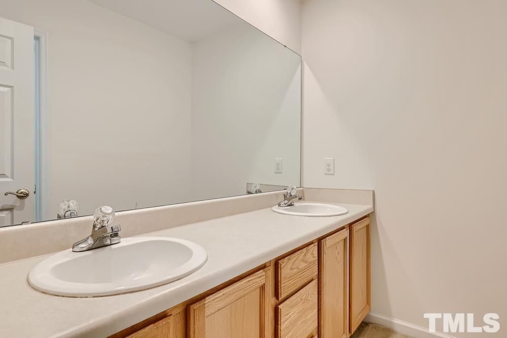 205 Bridgepath Drive Cary, NC 27513 - Photo 20 of 28 a bathroom with a sink and a mirror