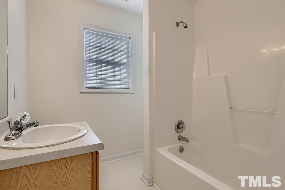 205 Bridgepath Drive Cary, NC 27513 - Photo 25 of 28 a bathroom with a granite countertop sink toilet and bathtub