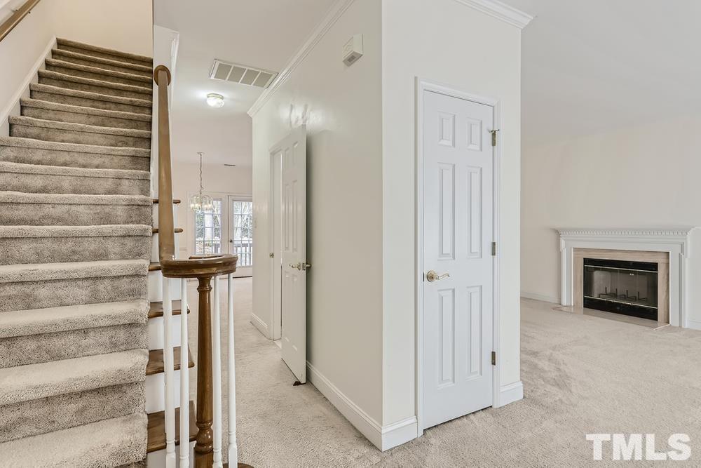 205 Bridgepath Drive Cary, NC 27513 - Photo 5 of 28 a view of hallway with stairs and a fireplace