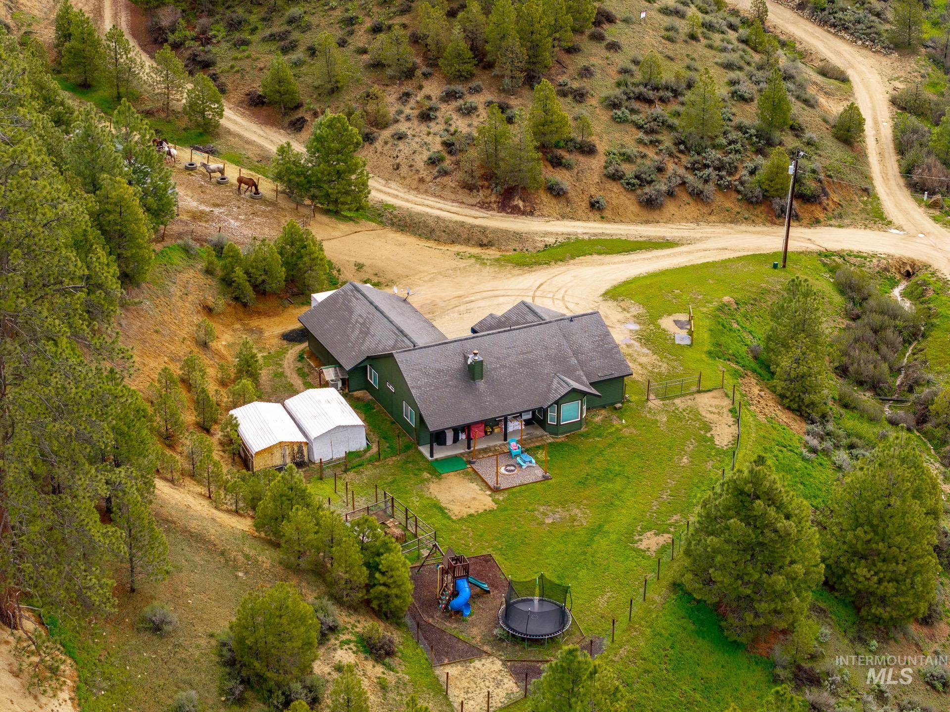 4 Round Up Circle Boise, ID 83716 - Photo 44 of 47 Single-story residence set on a sloped, expansive lot with mature trees and natural landscaping