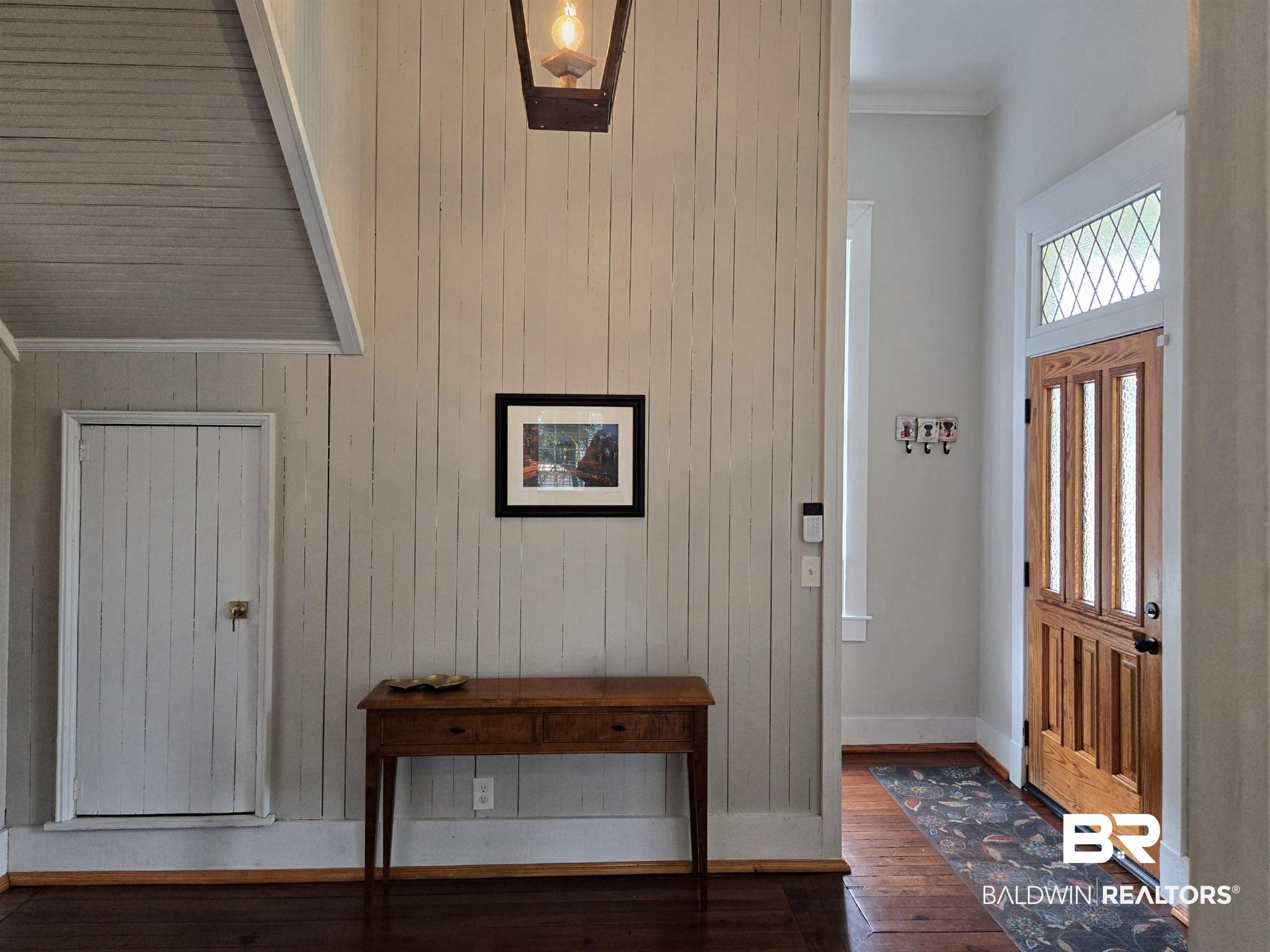 54 South Catherine Street Mobile, AL 36604 - Photo 8 of 55 Foyer with dark wood-style floors, wooden walls, baseboards, and crown molding