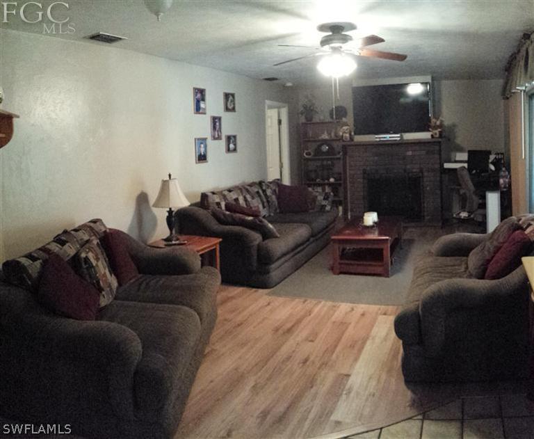 7436 Pebble Beach Road Fort Myers, FL 33967 - Photo 12 of 17 a living room with furniture and a fireplace