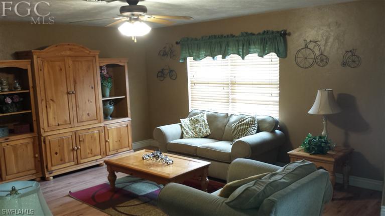 7436 Pebble Beach Road Fort Myers, FL 33967 - Photo 3 of 17 a living room with furniture and a large window